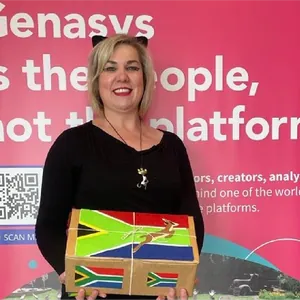 A colleague holding a box painted with the South African flag