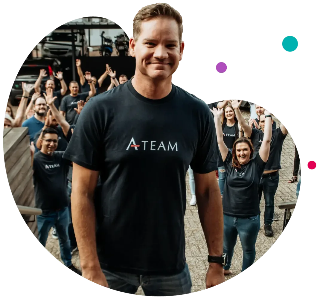 The Genasys team gathered outdoors with their arms in the air, and a smiling colleague in an A-Team T-shirt in front