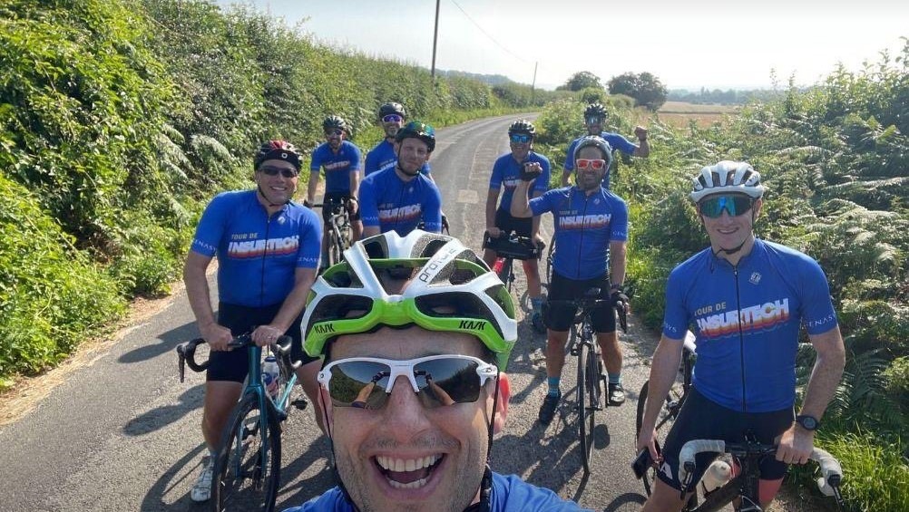 Genasys Tour de Insurtech riders in team jerseys on a country lane