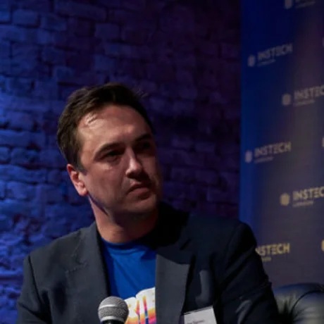 Two colleagues on a stage at an industry panel discussion