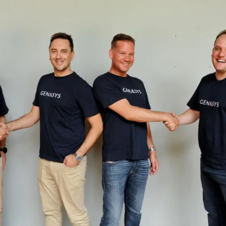 Four colleagues shaking hands in a line