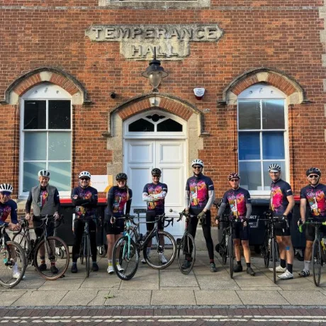 Nine colleagues with bicycles outside Temperance Hall