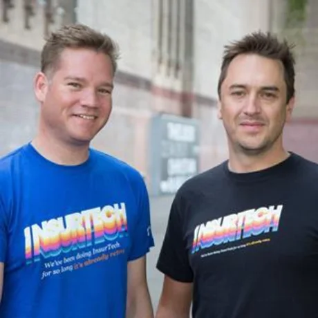 Two colleagues in matching InsurTech t-shirts