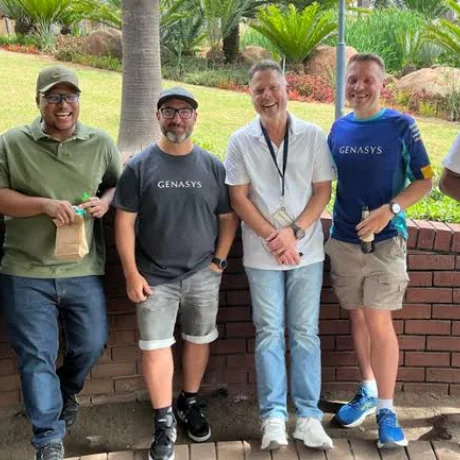 Six colleagues smiling together outdoors